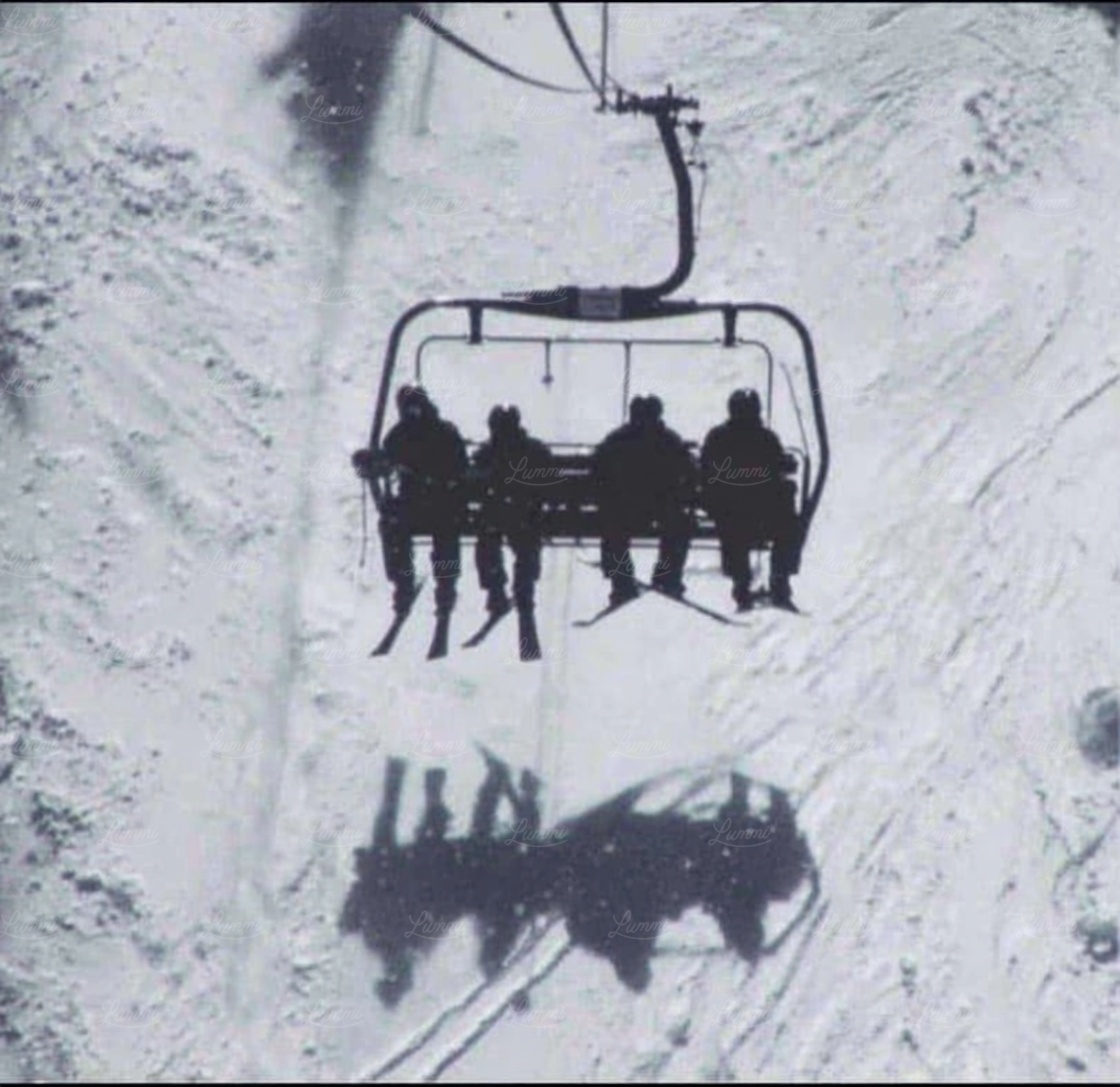 Skiers riding the chairlift up Snowshoe Mountain